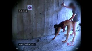 Security camera caught a naughty couple screwing in front of the garage exit