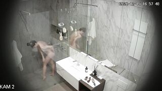 Busty girl washes and shaves in a large shower room