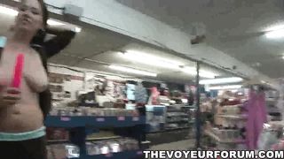 Busty babe bares it all at the porn store