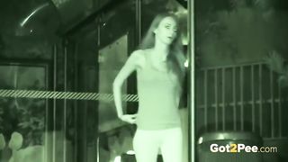 Naked babe with nice tits is pissing outside, while a horny voyeur is recording a video