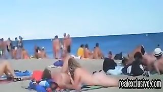 Horny voyeur is watching, while horny couples are having sex on the public nude beach