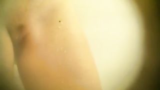 A horny voyeur is making a nice video, while a young girl is having a hot shower