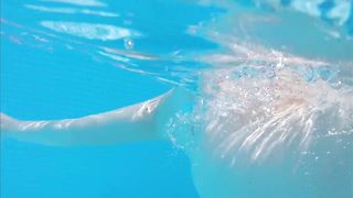 Busty Babe lounges on the pool and show us her giant boobs