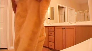 Naked girl drying her hair in a hotel room