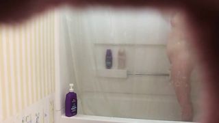 Hardly 18 dame is having a douche not knowing that her step-step-brother is seeing her