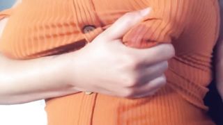 A fat woman in an orange blouse. Lactation through clothes and display of large milk boobs