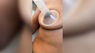 Autocompression of milk boobs in close-up. Lactation tits