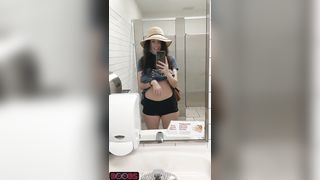 Topless in a public restroom. Forbidden tiktok content