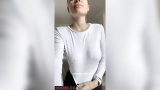 The smiling model's tits fell out from under her white blouse