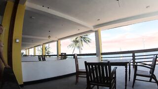 Nude lady ambles on the balcony disregarding the ocean