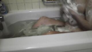 It's just a neighbor washing her bathtub. Rubbing foam on her tits.