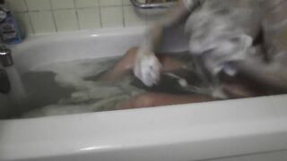 It's just a neighbor washing her bathtub. Rubbing foam on her tits.